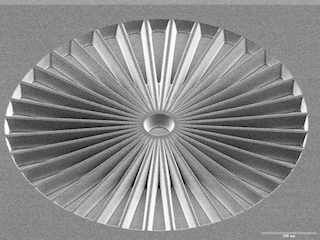 SEM-image of Stencil-mask with Siemens-star resolution-pattern and 15° sidewall-tapering.